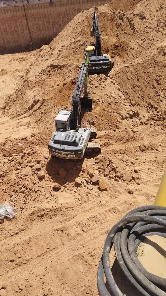 Paktia Star Transport excavators working inside a deep sandy excavation